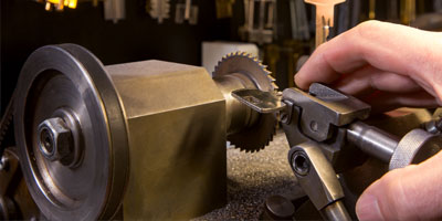 Key duplicating machine cutting an exact copy of a key